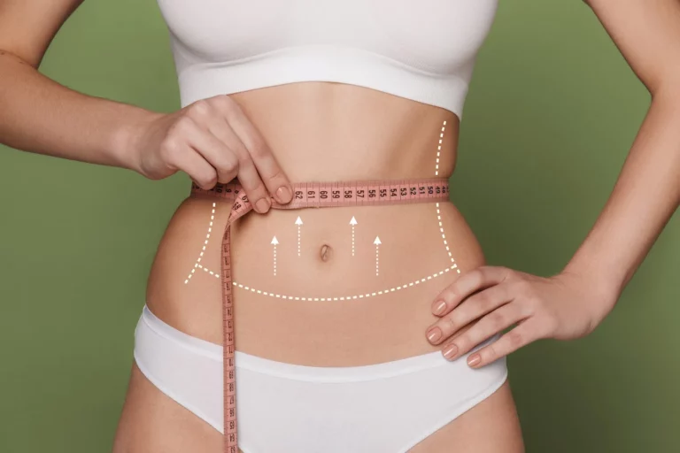 Woman measuring her waist with a tape measure  